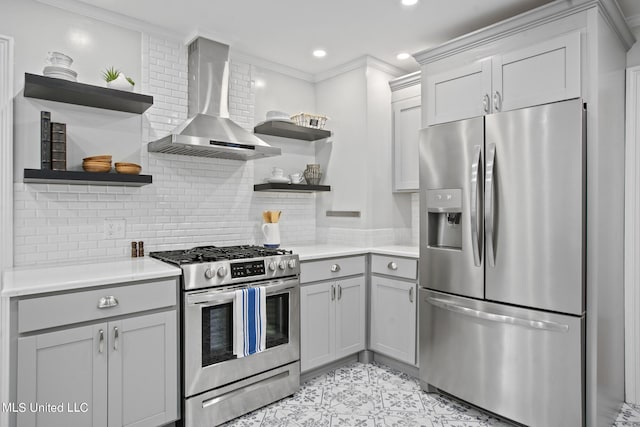 kitchen featuring crown molding, wall chimney exhaust hood, appliances with stainless steel finishes, and tasteful backsplash