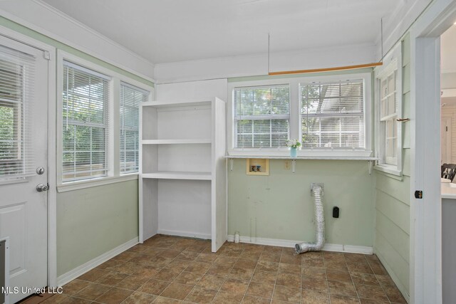 laundry area with hookup for an electric dryer, hookup for a washing machine, and a healthy amount of sunlight