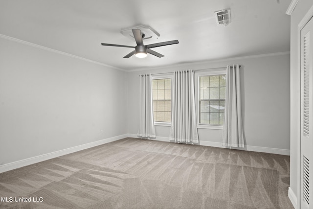 carpeted empty room featuring ornamental molding and ceiling fan