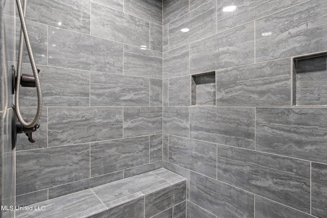 bathroom featuring tiled shower