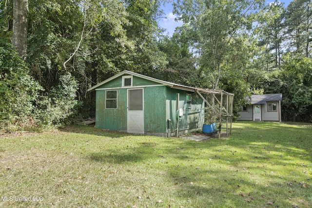 view of outbuilding featuring a lawn