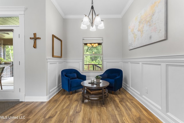 14463 Aerie Rd, Gulfport, MS 39503 - sitting room featuring wood finished floors, a chandelier, crown molding, a decorative wall, and a wainscoted wall
