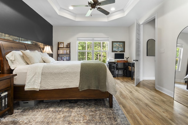 14463 Aerie Rd, Gulfport, MS 39503 - bedroom featuring wood finished floors, crown molding, a raised ceiling, recessed lighting, and arched walkways