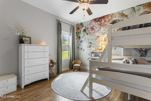 14463 Aerie Rd, Gulfport, MS 39503 - bedroom featuring dark wood finished floors, baseboards, ceiling fan, and an accent wall