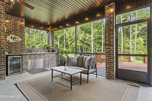14463 Aerie Rd, Gulfport, MS 39503 - sunroom / solarium with wine cooler, a ceiling fan, an outdoor hangout area, and a sink