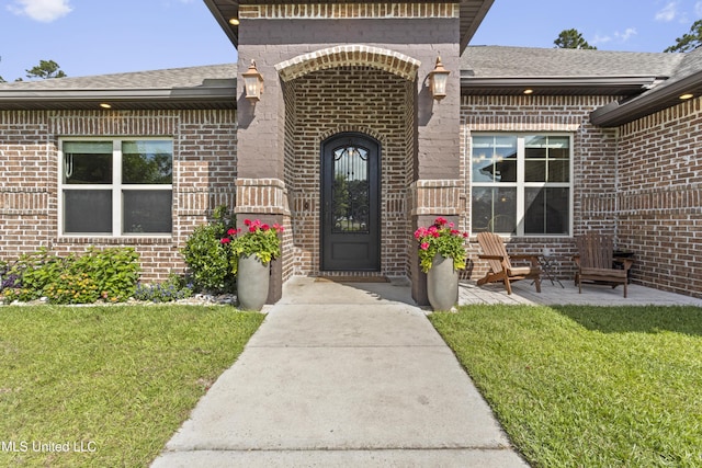 14463 Aerie Rd, Gulfport, MS 39503 - entrance to property with brick siding, a yard, and a shingled roof