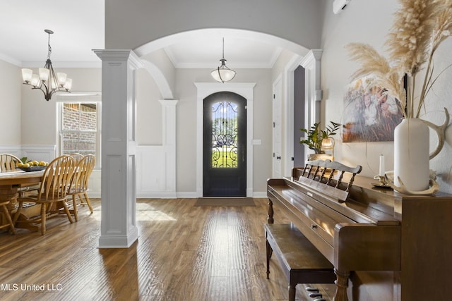 14463 Aerie Rd, Gulfport, MS 39503 - foyer entrance with arched walkways, wood finished floors, a chandelier, and ornamental molding