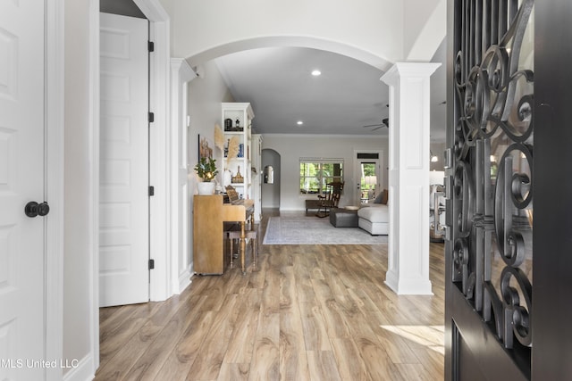 14463 Aerie Rd, Gulfport, MS 39503 - foyer with a ceiling fan, arched walkways, ornamental molding, light wood-style floors, and decorative columns