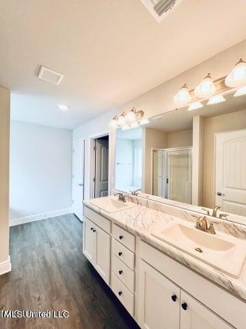 bathroom with vanity, hardwood / wood-style flooring, and an enclosed shower