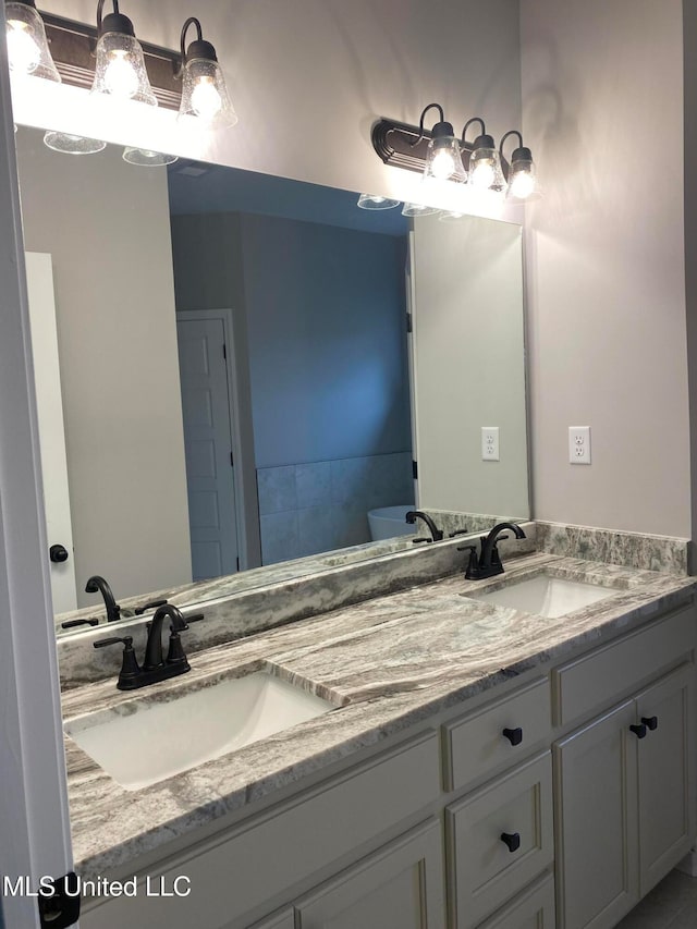 bathroom featuring vanity and a tub