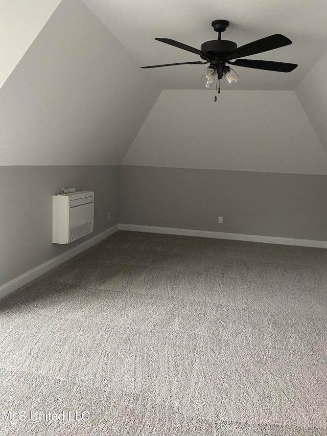 additional living space featuring ceiling fan, lofted ceiling, and carpet floors