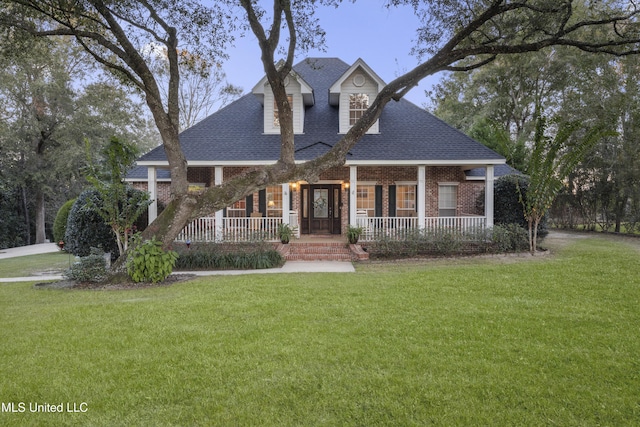 view of front of house with a porch and a front lawn