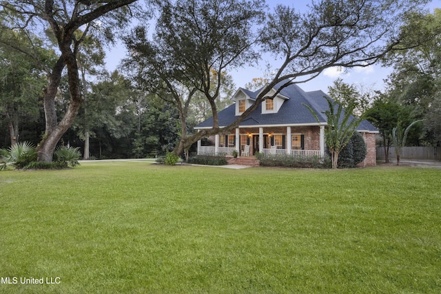 view of front of home with a porch and a front yard