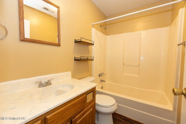 full bathroom with vanity, shower / washtub combination, a textured ceiling, and toilet