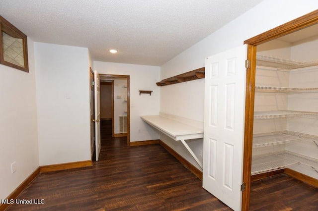 mudroom with a textured ceiling and dark hardwood / wood-style floors