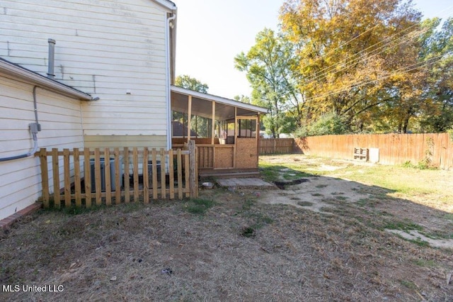 view of yard featuring a sunroom and a deck