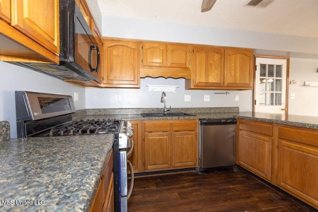 kitchen featuring dark hardwood / wood-style floors, stainless steel appliances, and sink