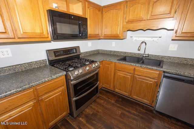 kitchen with stainless steel appliances, sink, and dark hardwood / wood-style flooring