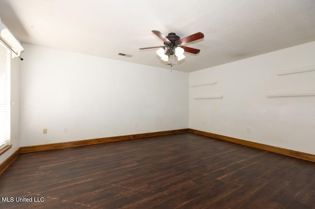 empty room with ceiling fan and dark hardwood / wood-style floors