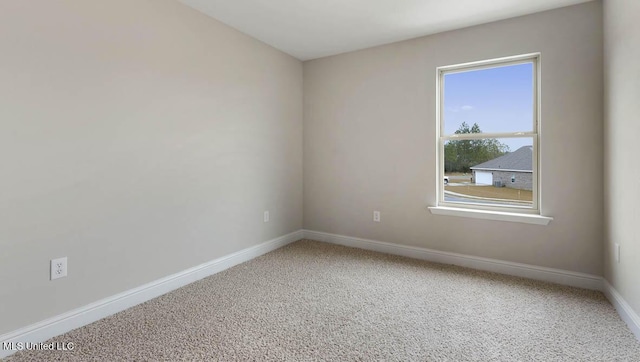 unfurnished room with baseboards and carpet flooring