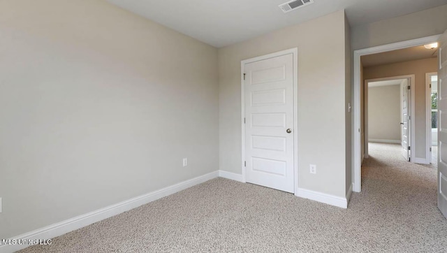 unfurnished bedroom with carpet, visible vents, and baseboards