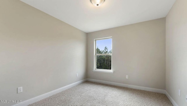 unfurnished room with light carpet and baseboards