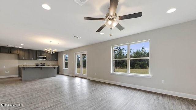 kitchen featuring recessed lighting, visible vents, baseboards, light wood-type flooring, and stainless steel microwave