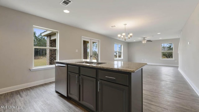 kitchen featuring visible vents, a sink, stainless steel dishwasher, and wood finished floors