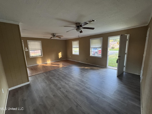 unfurnished room with plenty of natural light, dark hardwood / wood-style floors, and ceiling fan