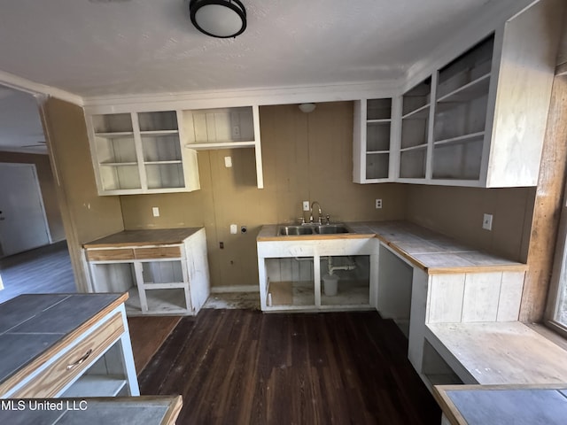 kitchen featuring tile counters, dark hardwood / wood-style flooring, and sink