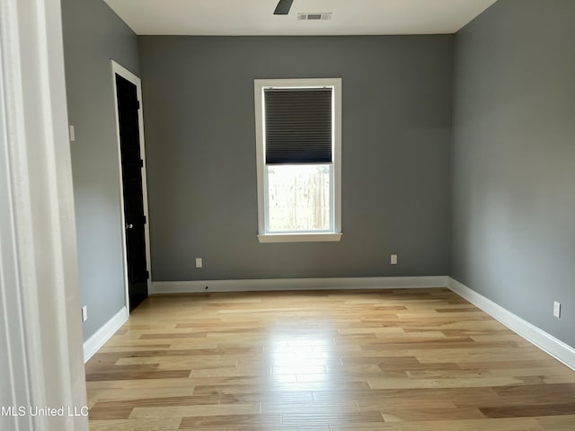 unfurnished room featuring ceiling fan and light wood-type flooring