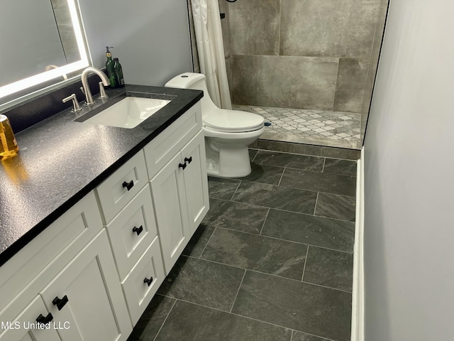 bathroom featuring vanity, toilet, and a shower with shower curtain