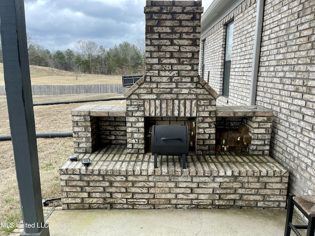 view of patio / terrace with an outdoor brick fireplace