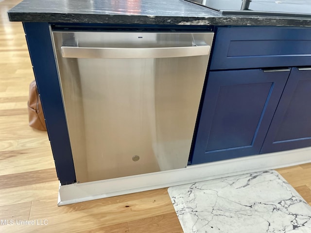 room details with dishwasher, blue cabinetry, and light wood-type flooring