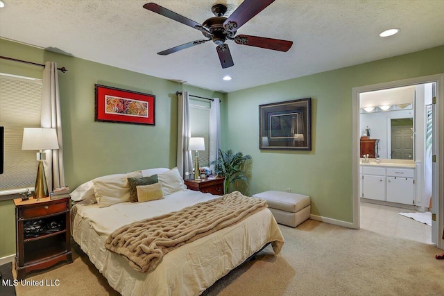 bedroom with baseboards, light carpet, recessed lighting, ensuite bathroom, and a textured ceiling