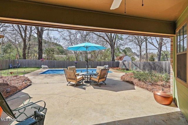 view of patio / terrace featuring a fenced in pool, a fenced backyard, and ceiling fan