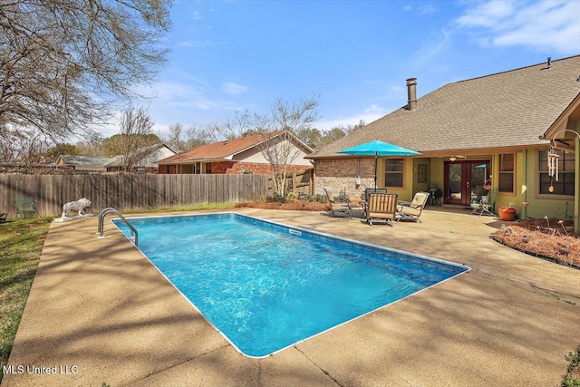 view of swimming pool with a patio area, a fenced in pool, french doors, and a fenced backyard