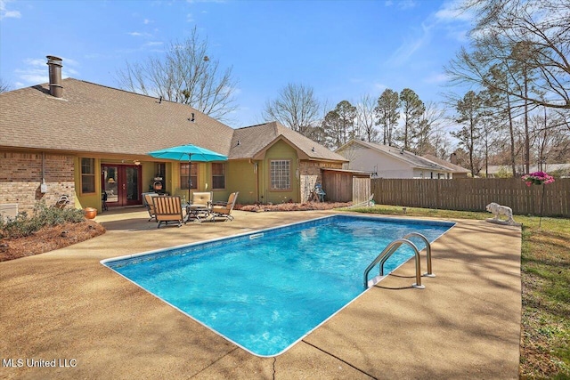 view of swimming pool with a patio area, a fenced in pool, french doors, and fence