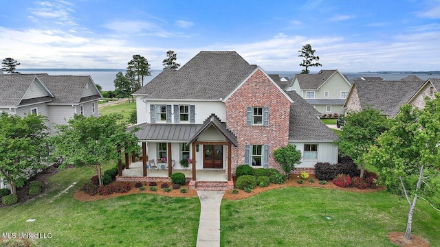 233 Arbor Trl, Brandon, MS 39047 - view of front of house featuring a porch, a front lawn, a standing seam roof, and brick siding