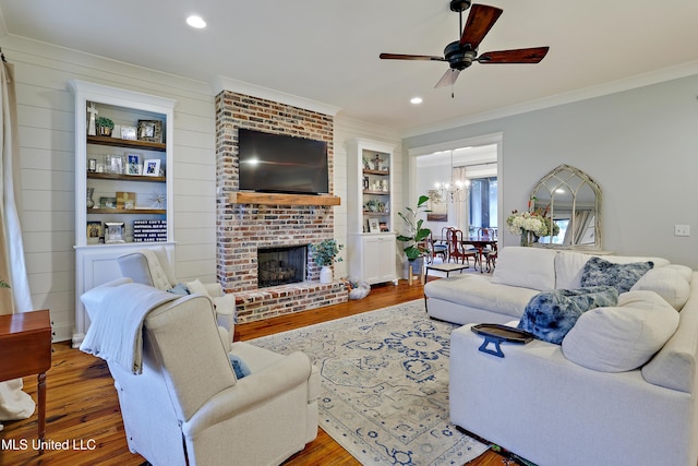 233 Arbor Trl, Brandon, MS 39047 - living room with wood finished floors, ceiling fan with notable chandelier, and crown molding