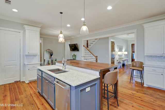 233 Arbor Trl, Brandon, MS 39047 - kitchen featuring a breakfast bar, white cabinets, backsplash, light wood finished floors, and a sink
