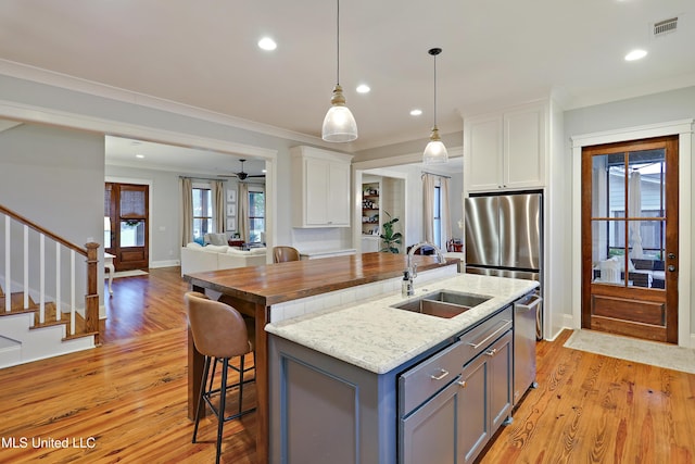 233 Arbor Trl, Brandon, MS 39047 - kitchen featuring visible vents, a kitchen island with sink, white cabinets, and a sink
