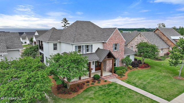 233 Arbor Trl, Brandon, MS 39047 - traditional home featuring stucco siding, a standing seam roof, metal roof, stone siding, and a front lawn