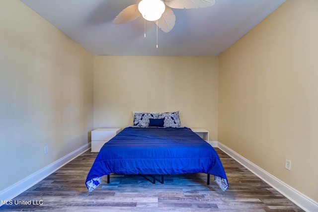 bedroom featuring dark hardwood / wood-style flooring and ceiling fan