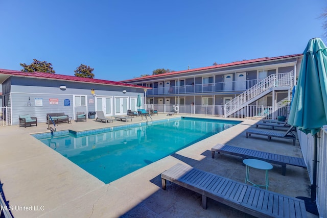 view of swimming pool with a patio area