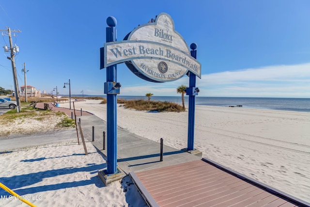 exterior space with a water view and a view of the beach