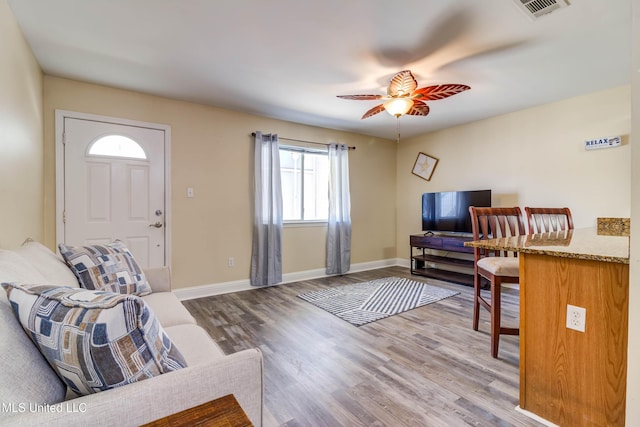 living room with hardwood / wood-style flooring and ceiling fan