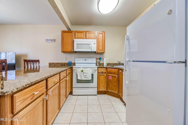 kitchen with light stone countertops, sink, kitchen peninsula, white appliances, and light tile patterned floors