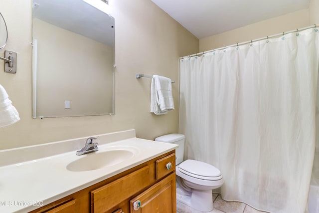 bathroom with a shower with shower curtain, tile patterned floors, vanity, and toilet