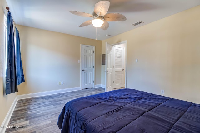 unfurnished bedroom with hardwood / wood-style floors, ceiling fan, and a closet